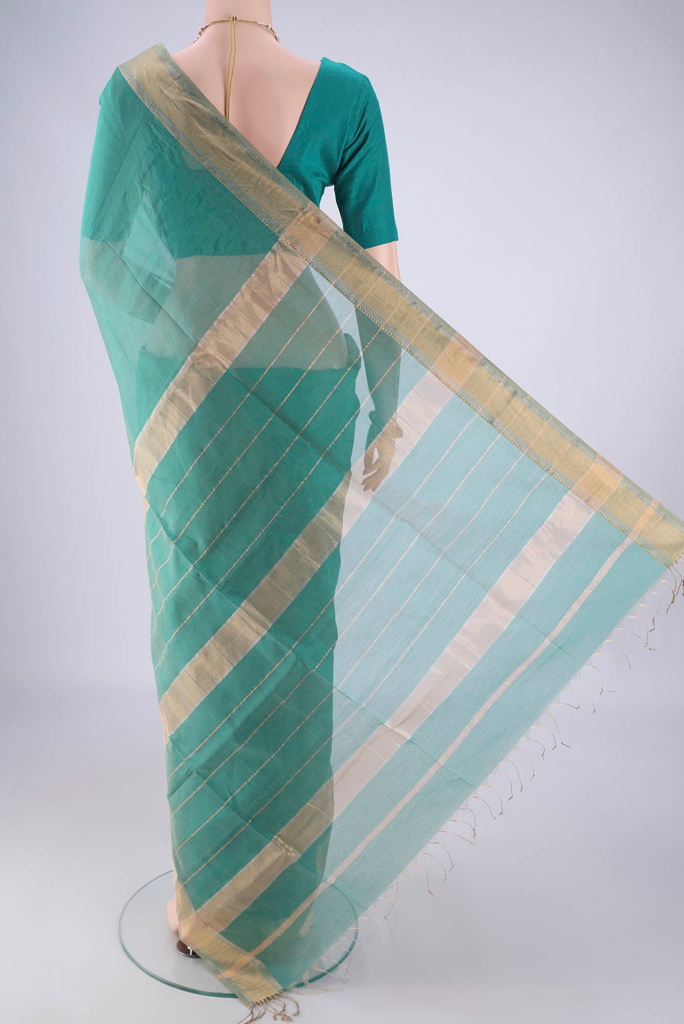 Flat view of Sea Green Maheshwari Silk Cotton Saree with Stripes on the body and Zari Border. 