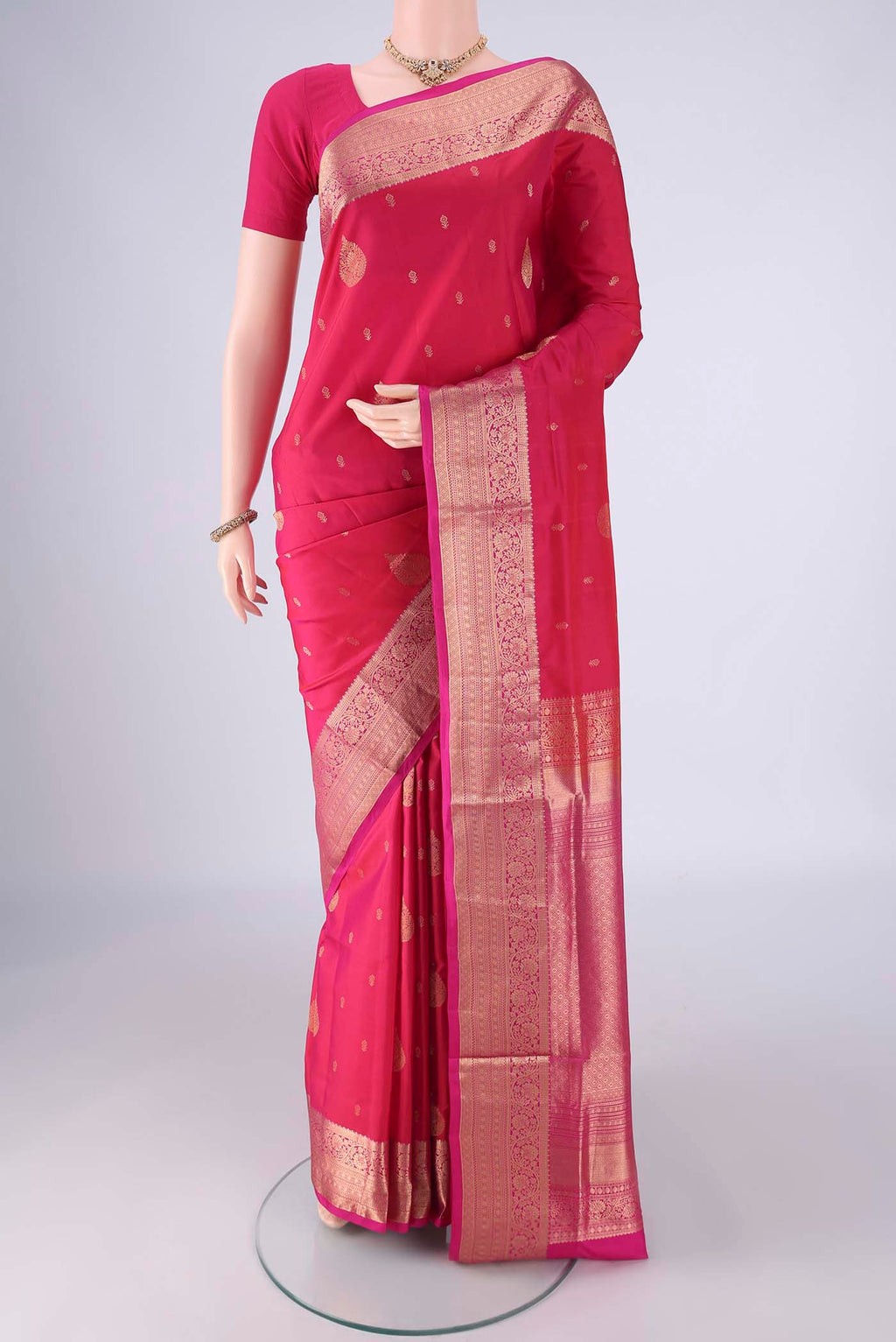 Pink Soft Silk Saree with Zari Butta on the body and Zari Border.  displayed on a mannequin