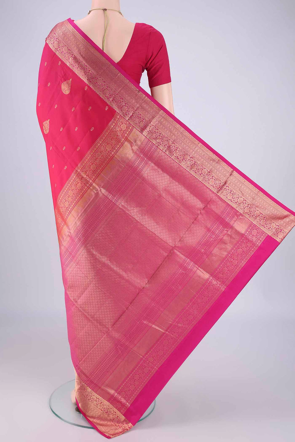 Flat view of Pink Soft Silk Saree with Zari Butta on the body and Zari Border. 