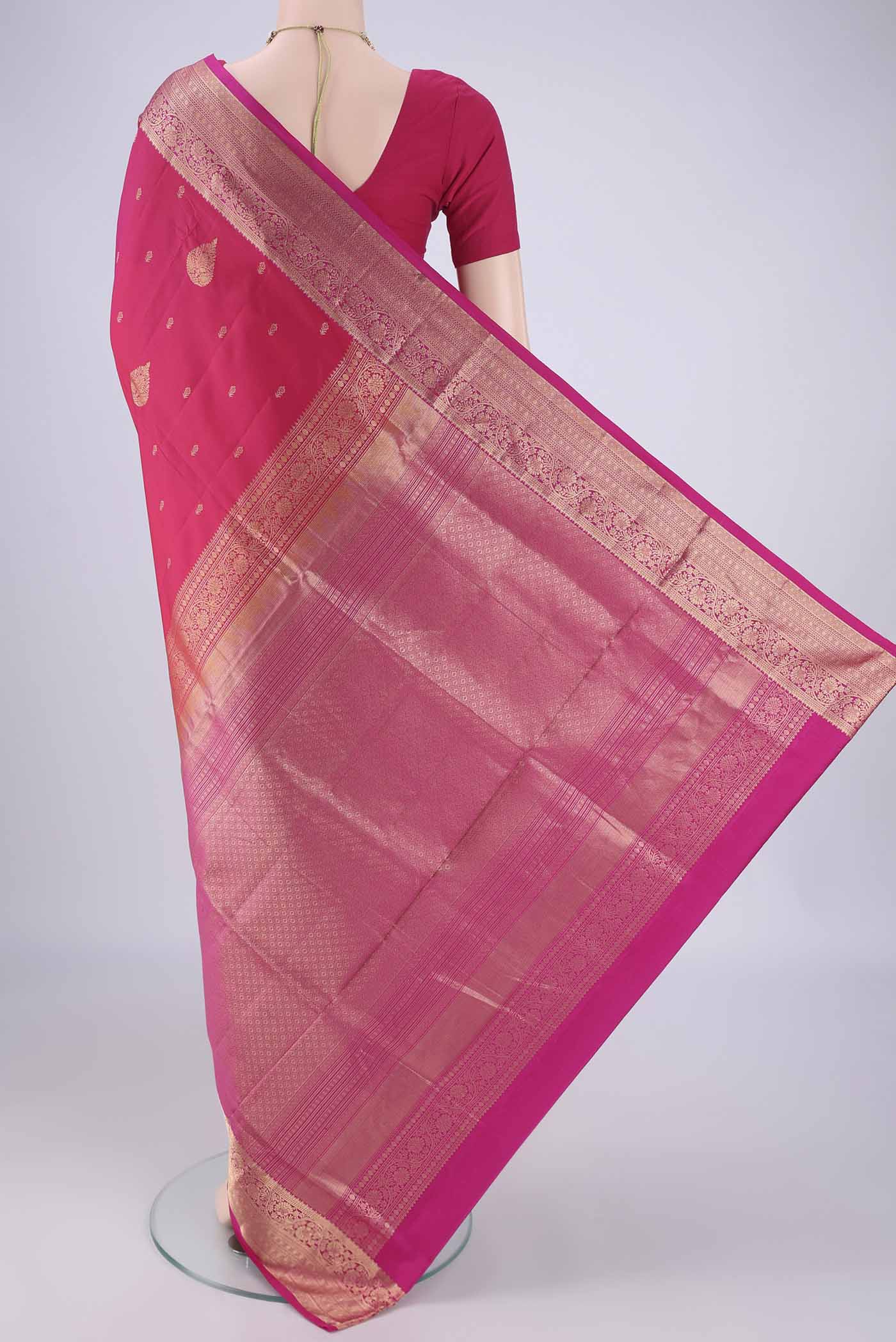 Flat view of Pink Soft Silk Saree with Zari Butta on the body and Zari Border. 