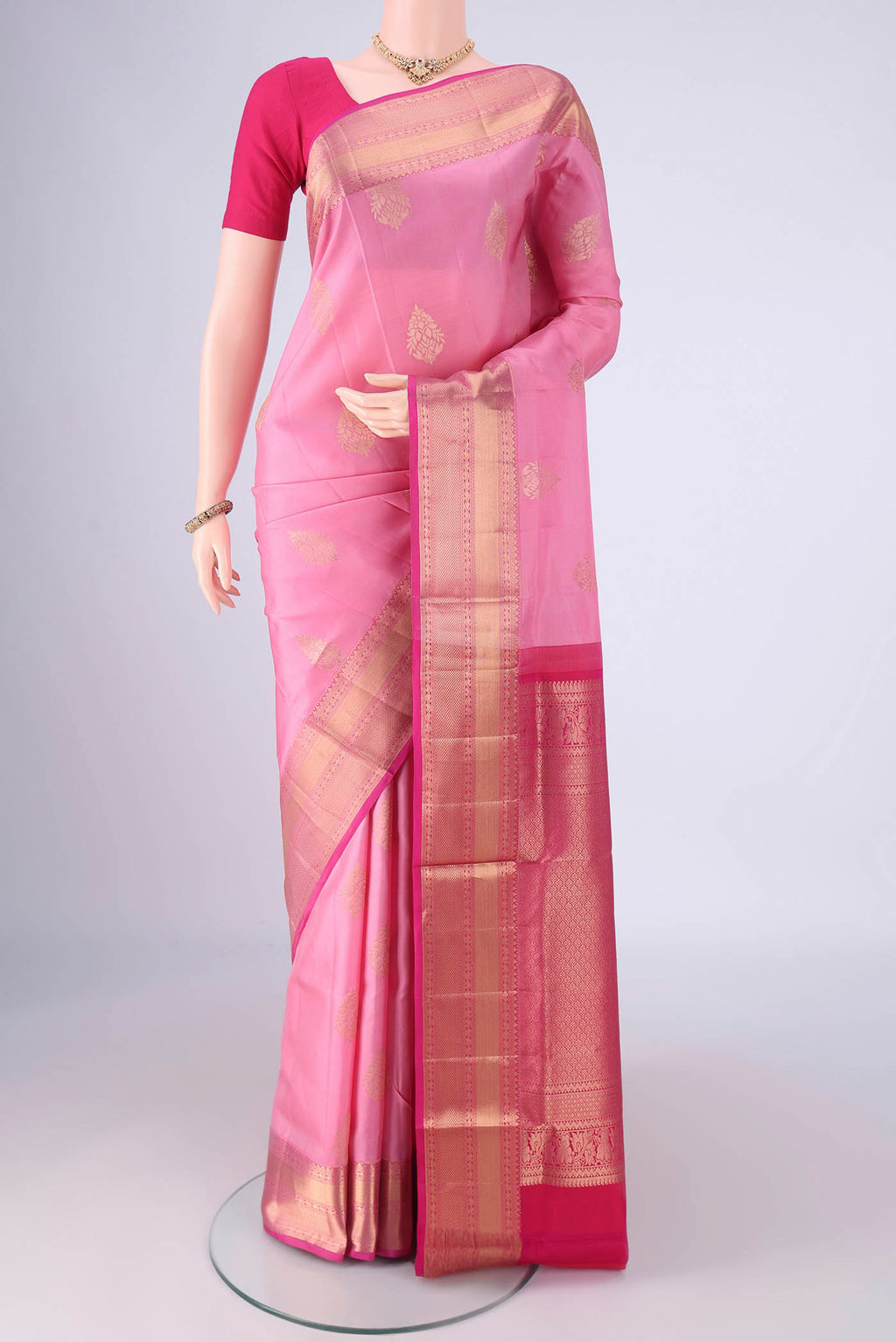 Rose pink Soft Silk Saree with Zari Butta on the body and Zari Border.  displayed on a mannequin