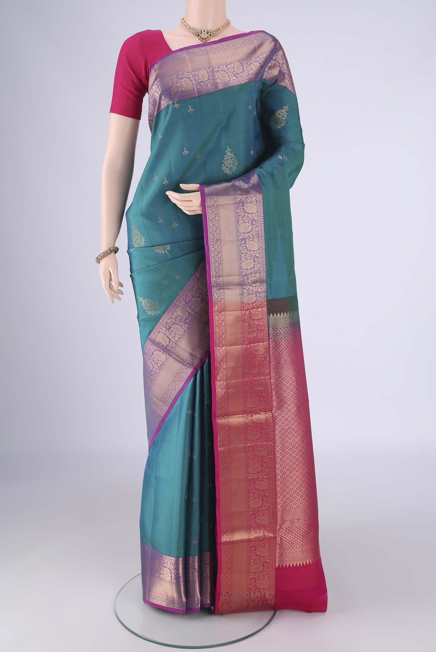 Turquoise Soft Silk Saree with Zari Butta on the body and Zari Border.  displayed on a mannequin