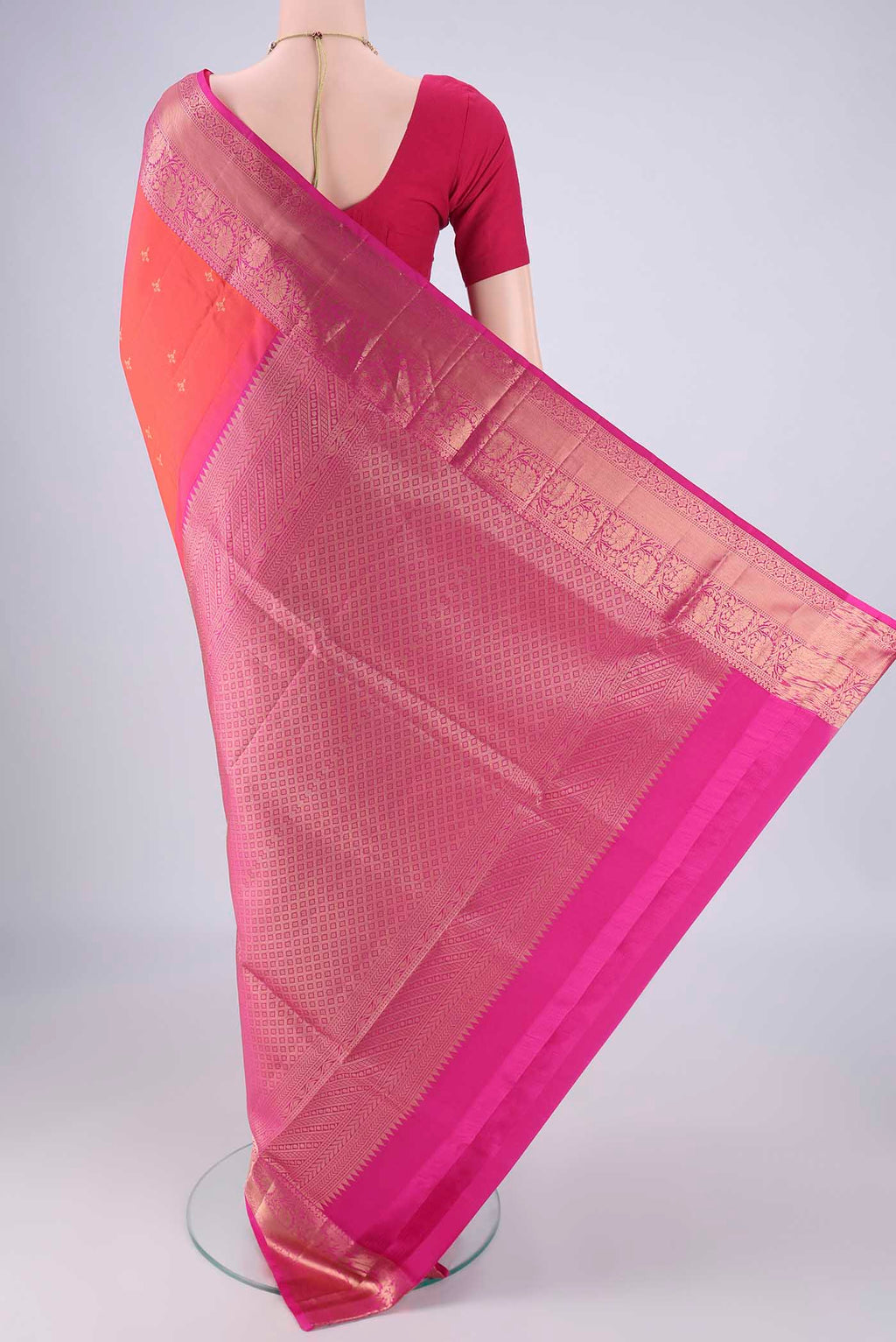 Flat view of Orange Soft Silk Saree with Zari Butta on the body and Zari Border. 