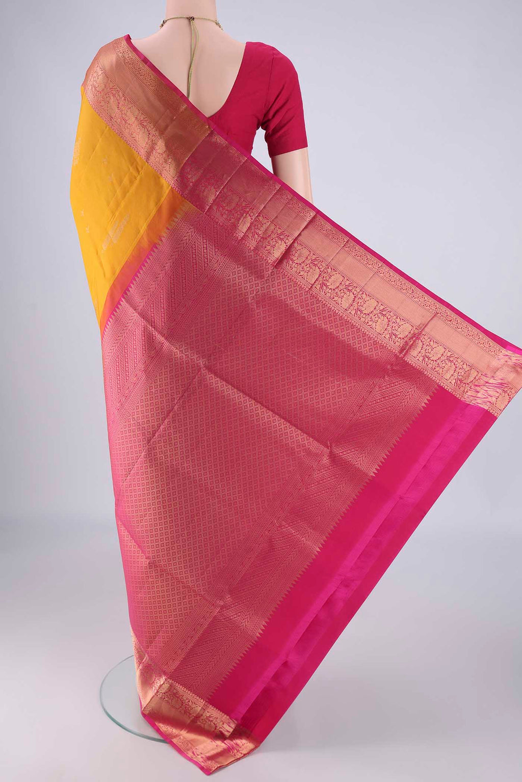 Flat view of Mustard Soft Silk Saree with Zari Butta on the body and Zari Border. 