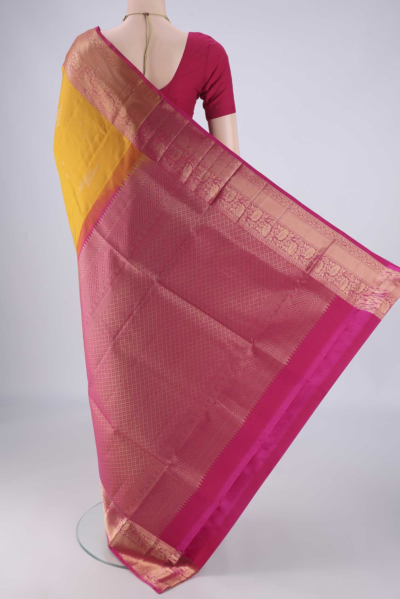 Flat view of Mustard Soft Silk Saree with Zari Butta on the body and Zari Border. 