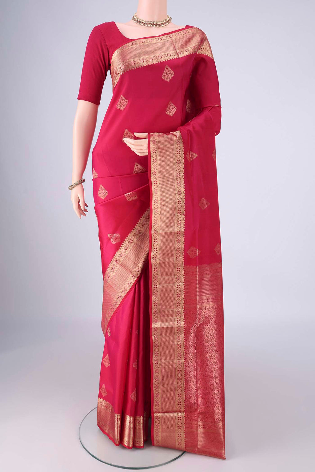 Dark Pink Soft Silk Saree with Zari Butta on the body and Zari Border.  displayed on a mannequin