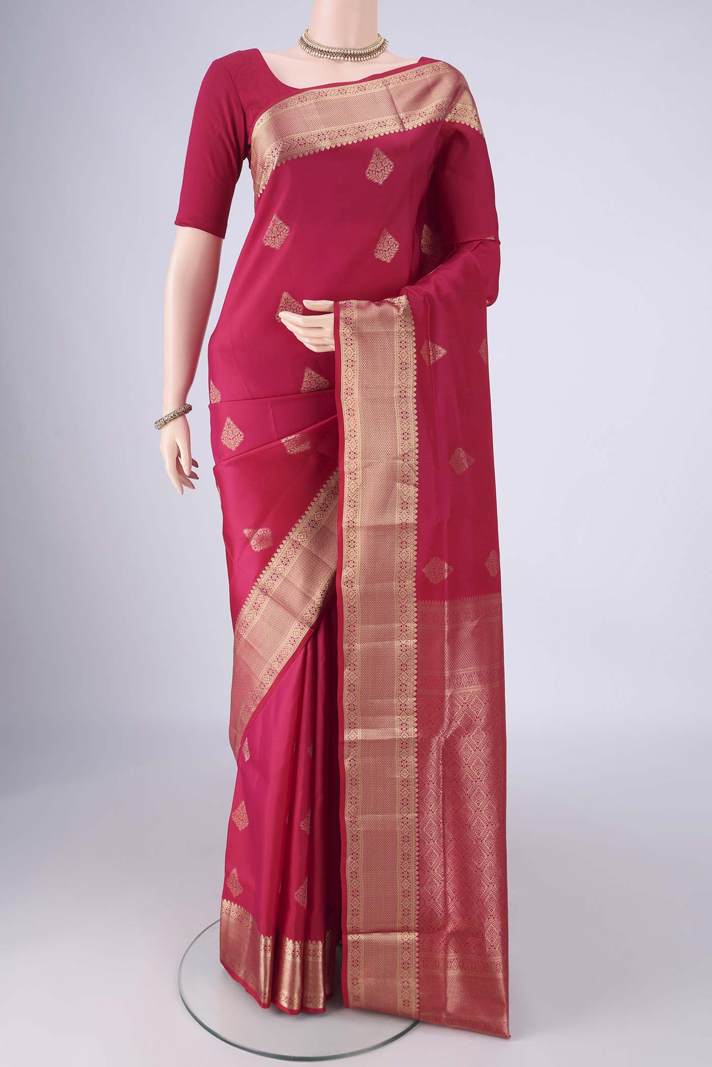 Dark Pink Soft Silk Saree with Zari Butta on the body and Zari Border.  displayed on a mannequin