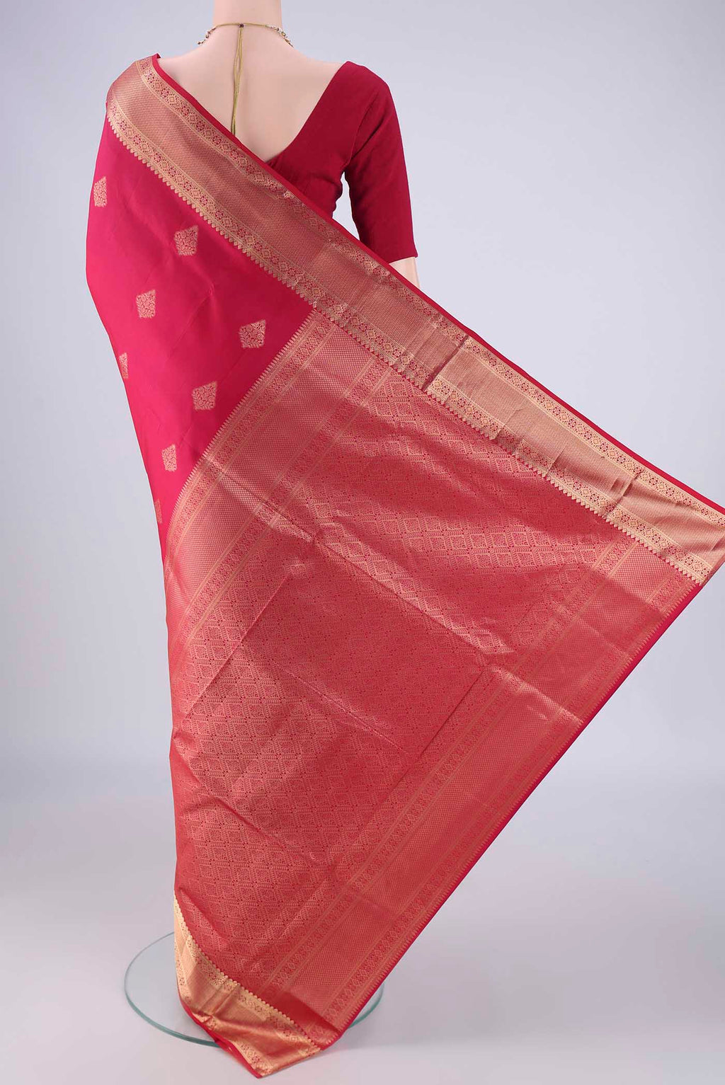 Flat view of Dark Pink Soft Silk Saree with Zari Butta on the body and Zari Border. 