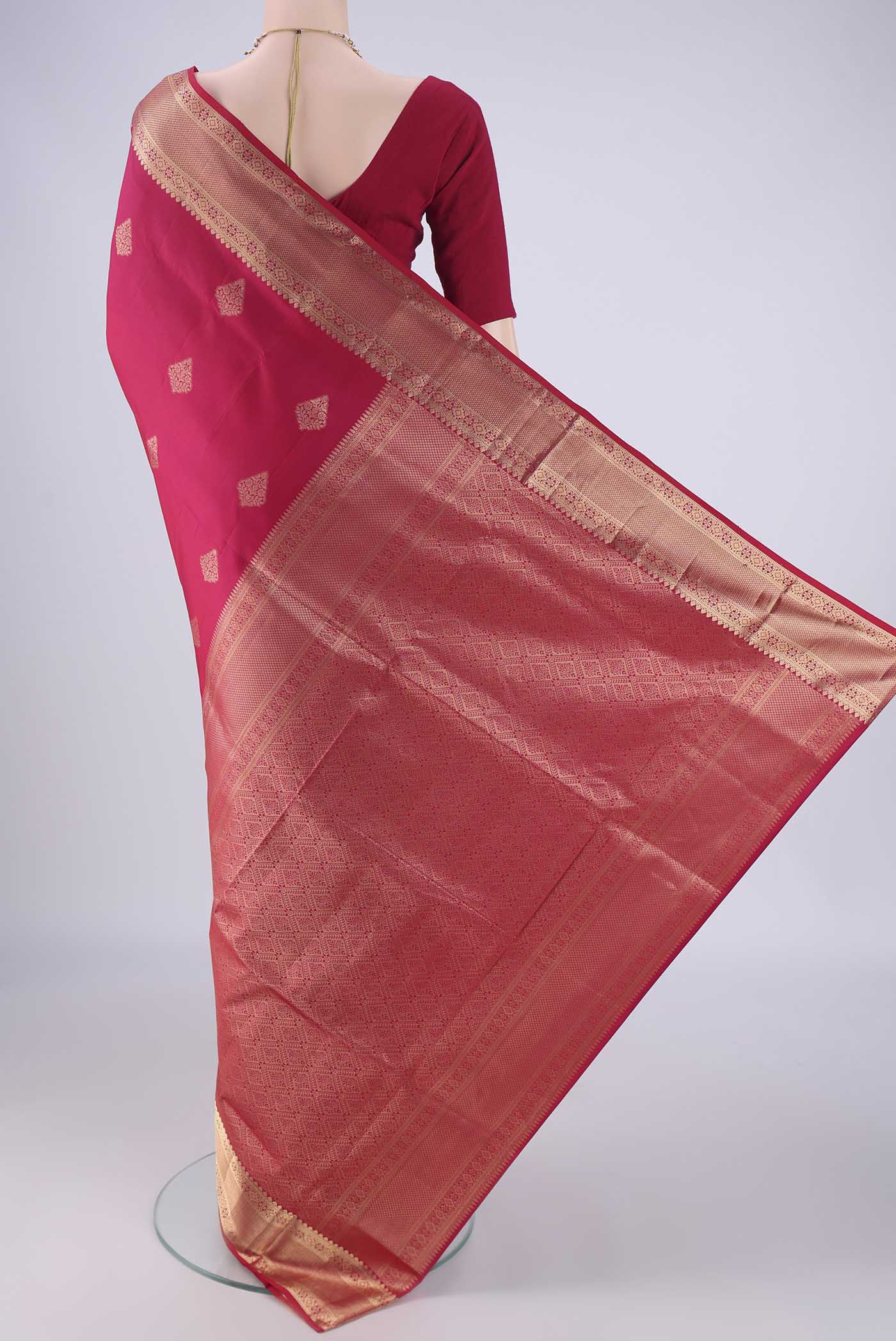 Flat view of Dark Pink Soft Silk Saree with Zari Butta on the body and Zari Border. 