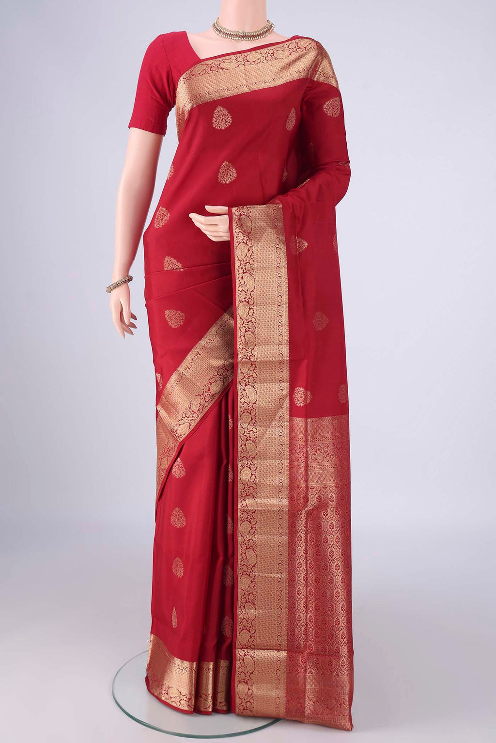 Maroon Soft Silk Saree with Zari Butta on the body and Zari Border.  displayed on a mannequin