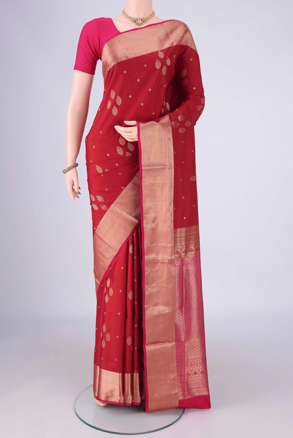 Maroon Soft Silk Saree with Zari Butta on the body and Zari Border.  displayed on a mannequin