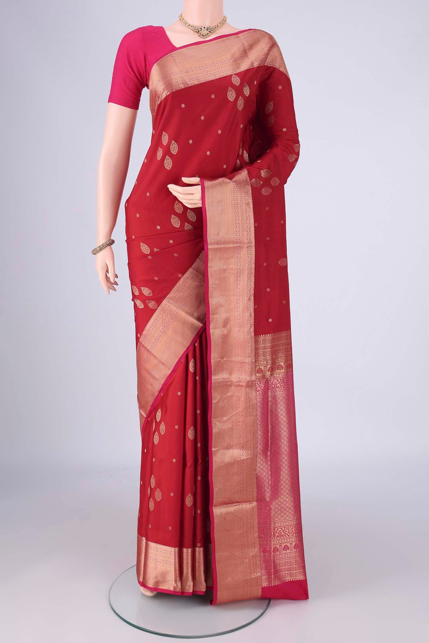 Maroon Soft Silk Saree with Zari Butta on the body and Zari Border.  displayed on a mannequin