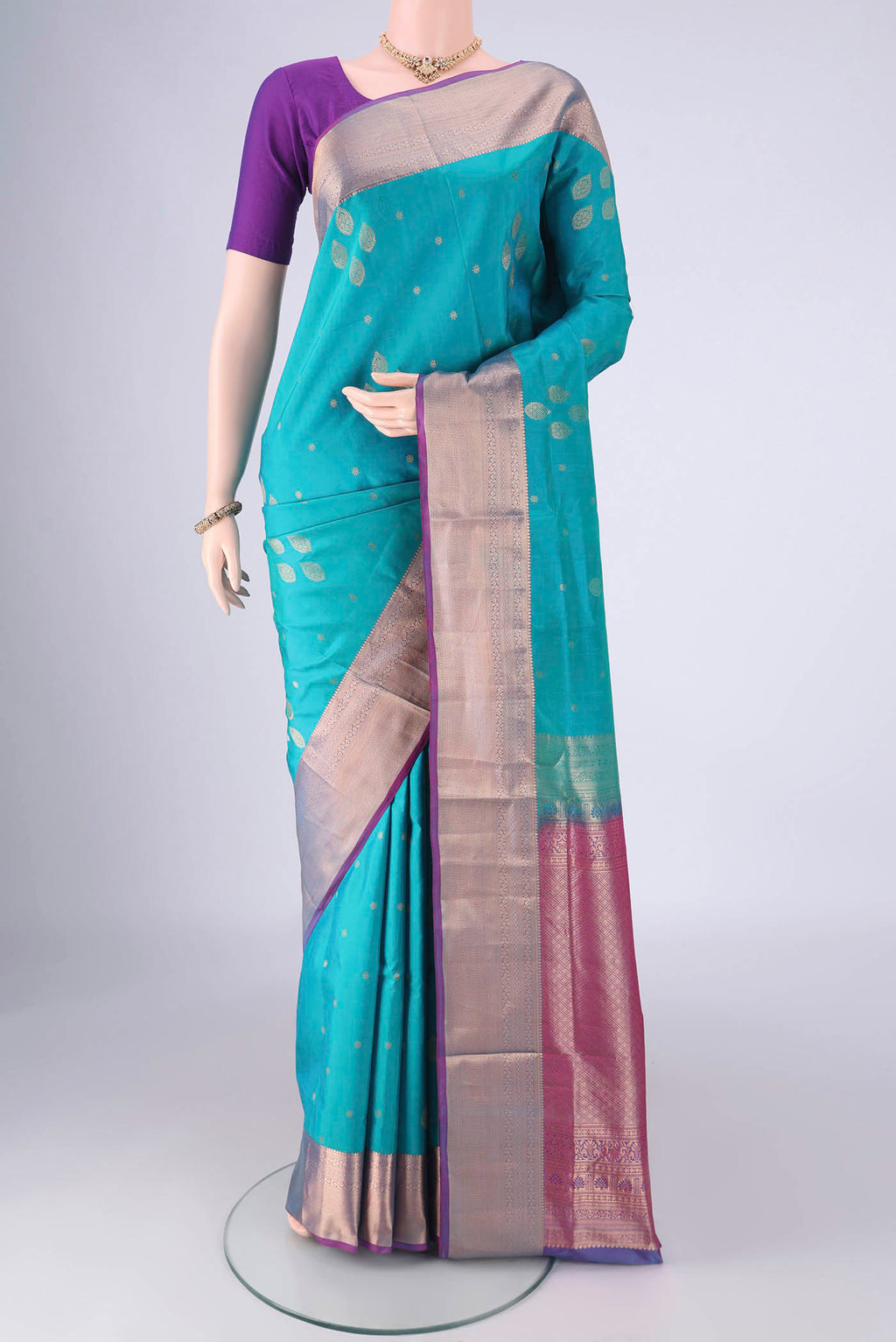 Blue Soft Silk Saree with Zari Butta on the body and Zari Border.  displayed on a mannequin