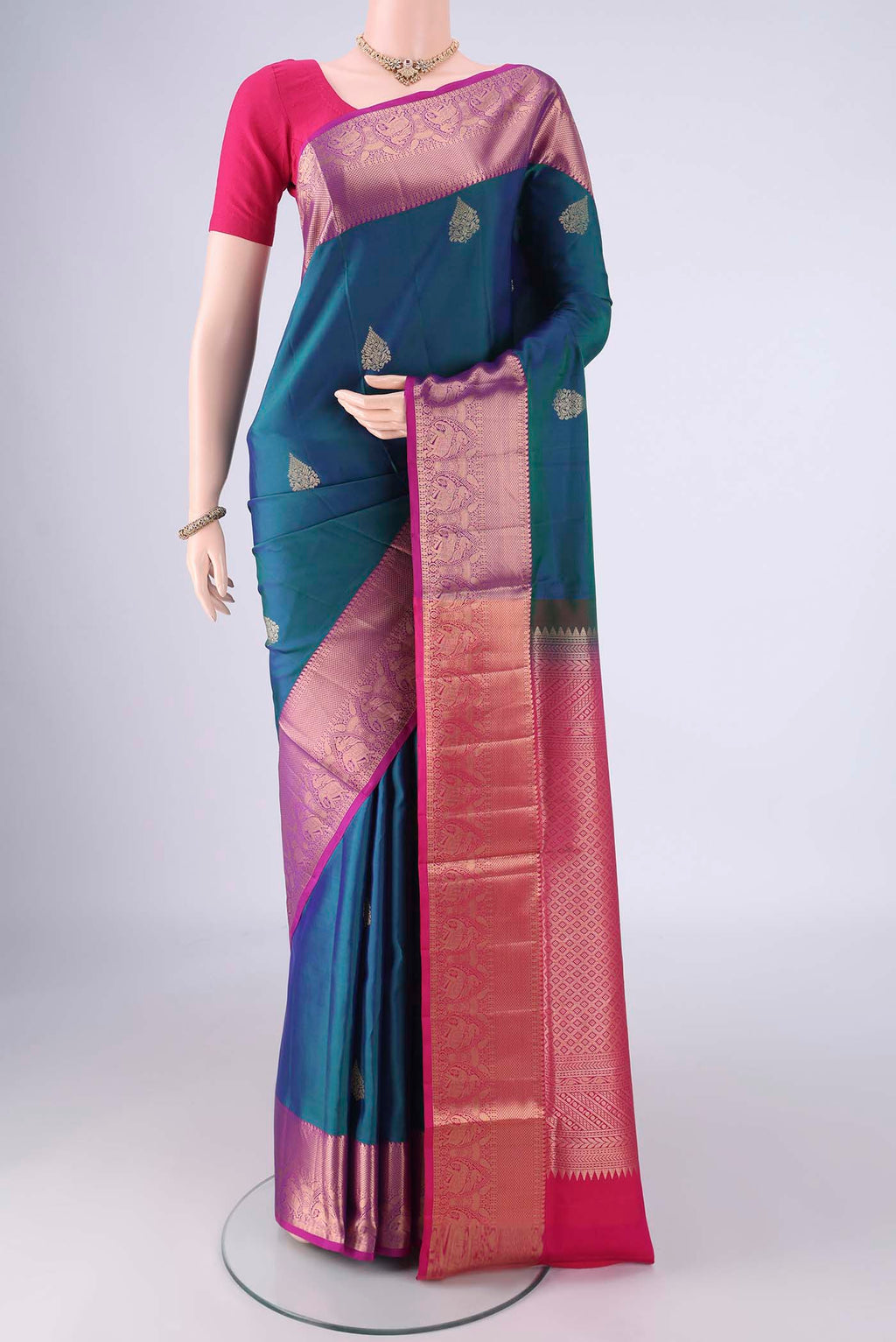 Blue Soft Silk Saree with Zari Butta on the body and Zari Border.  displayed on a mannequin