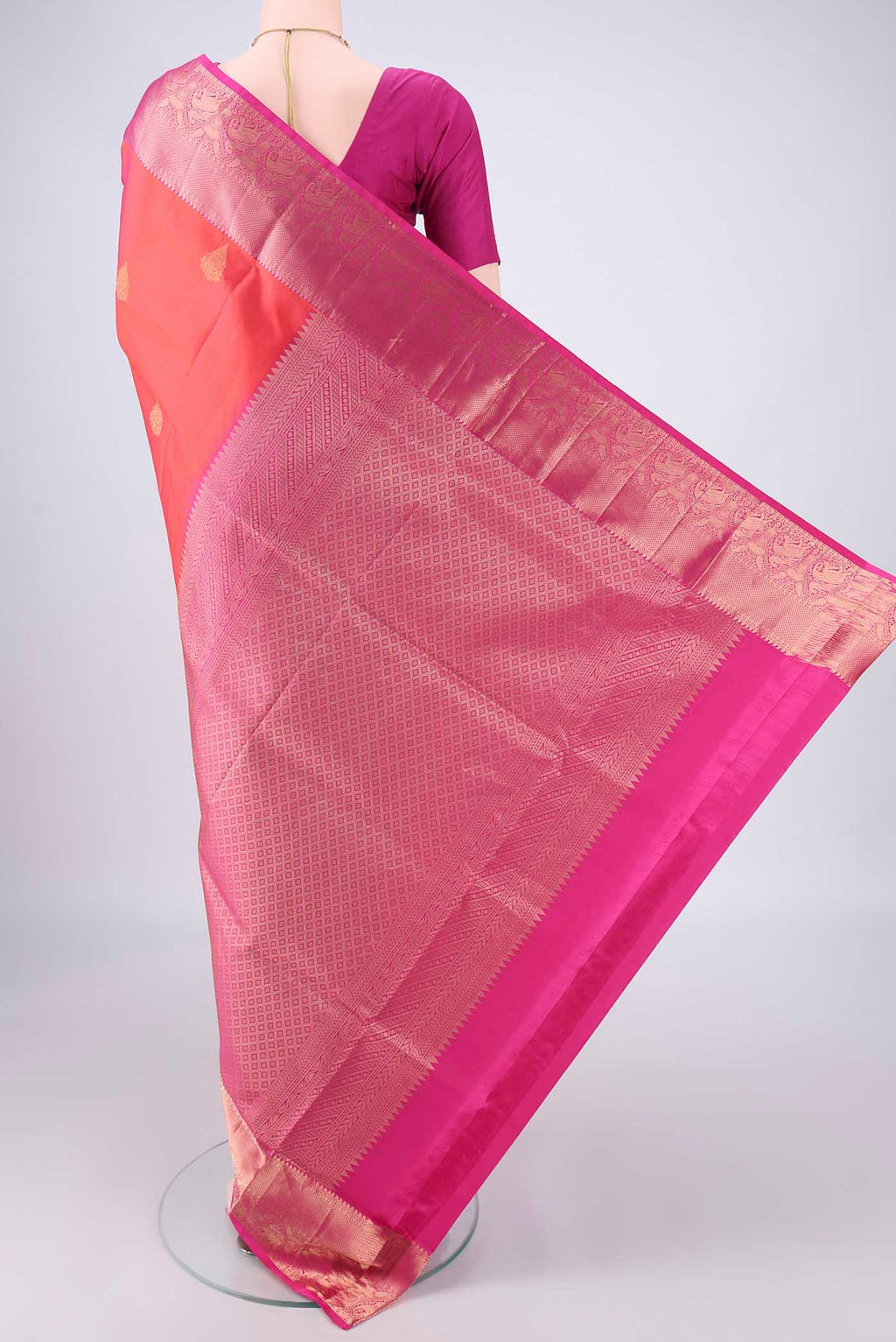 Flat view of Orange Soft Silk Saree with Zari Butta on the body and Zari Border. 