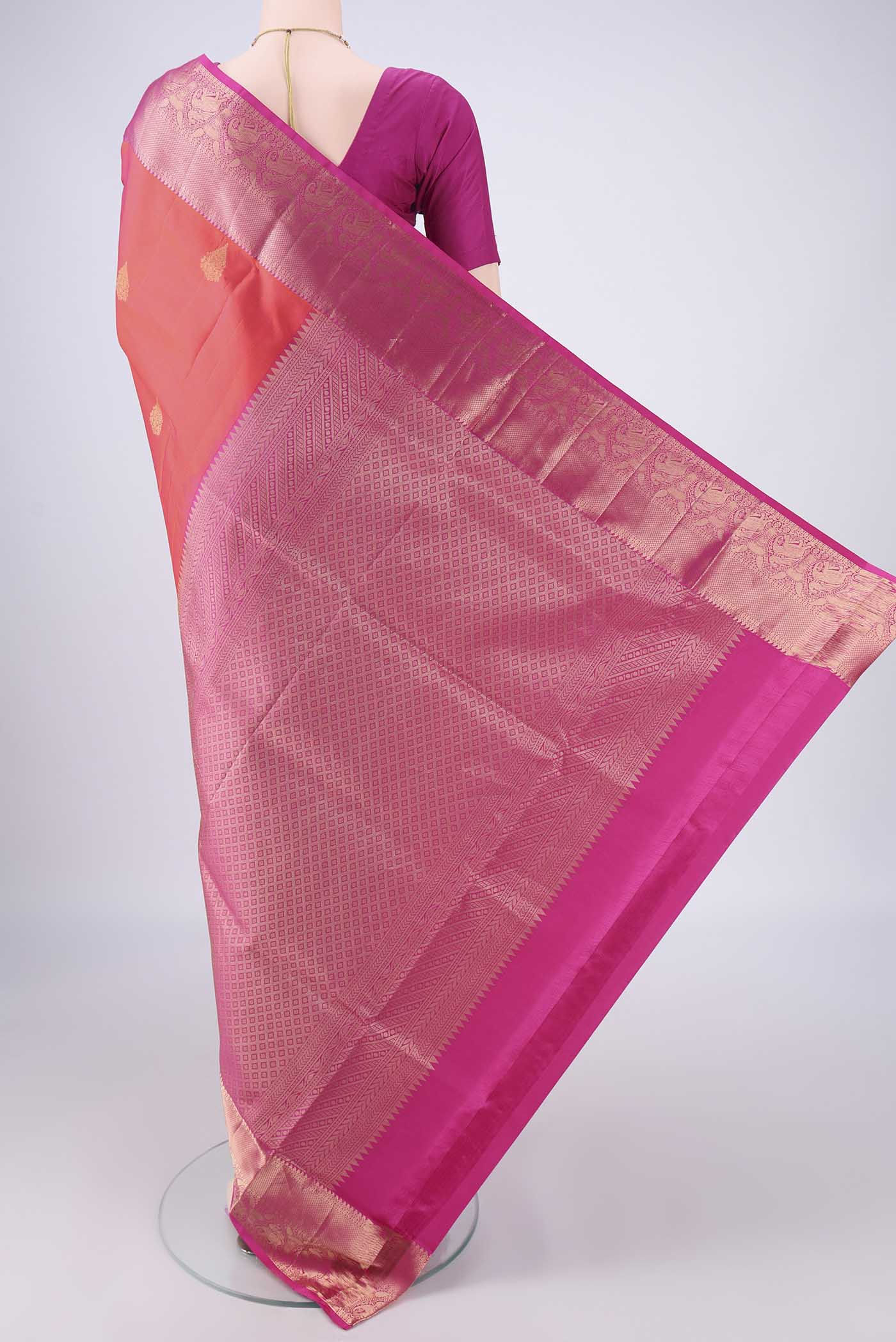 Flat view of Orange Soft Silk Saree with Zari Butta on the body and Zari Border. 