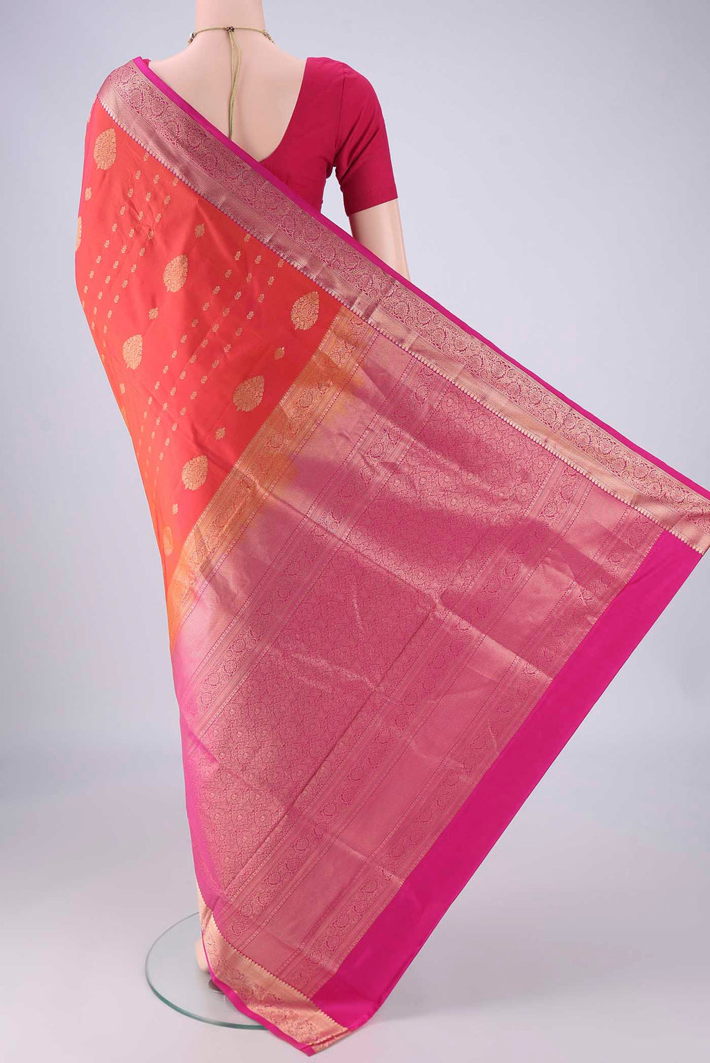 Flat view of Orange Soft Silk Saree with Zari Butta on the body and Zari Border. 