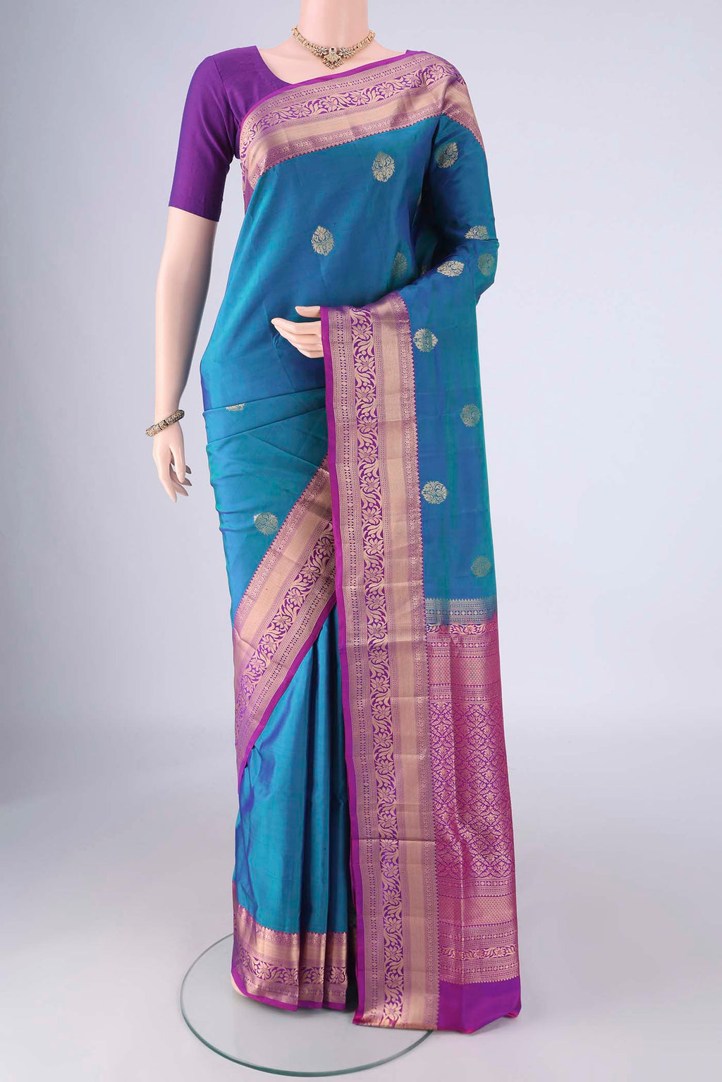 Blue Soft Silk Saree with Zari Butta on the body and Zari Border.  displayed on a mannequin