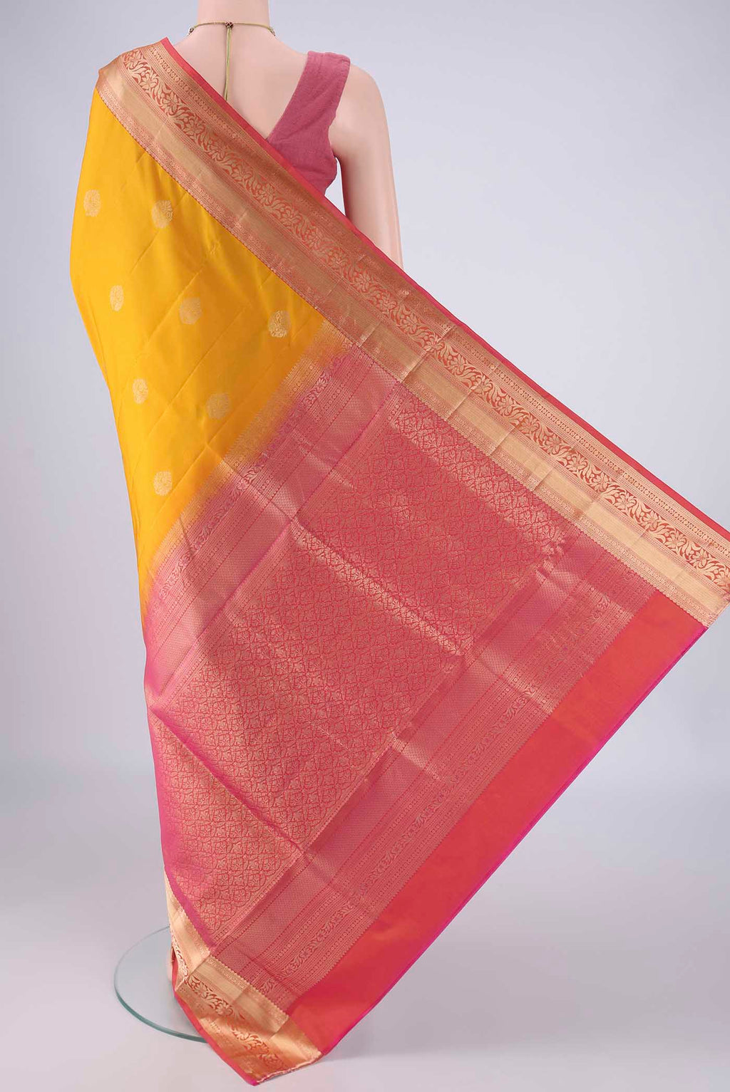 Flat view of Yellow Soft Silk Saree with Zari Butta on the body and Zari Border. 