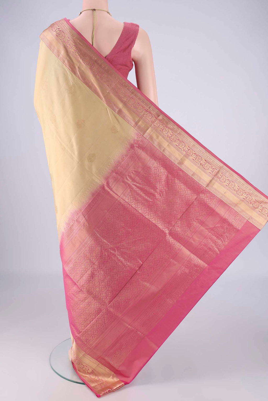 Flat view of Beige Soft Silk Saree with Zari Butta on the body and Zari Border. 