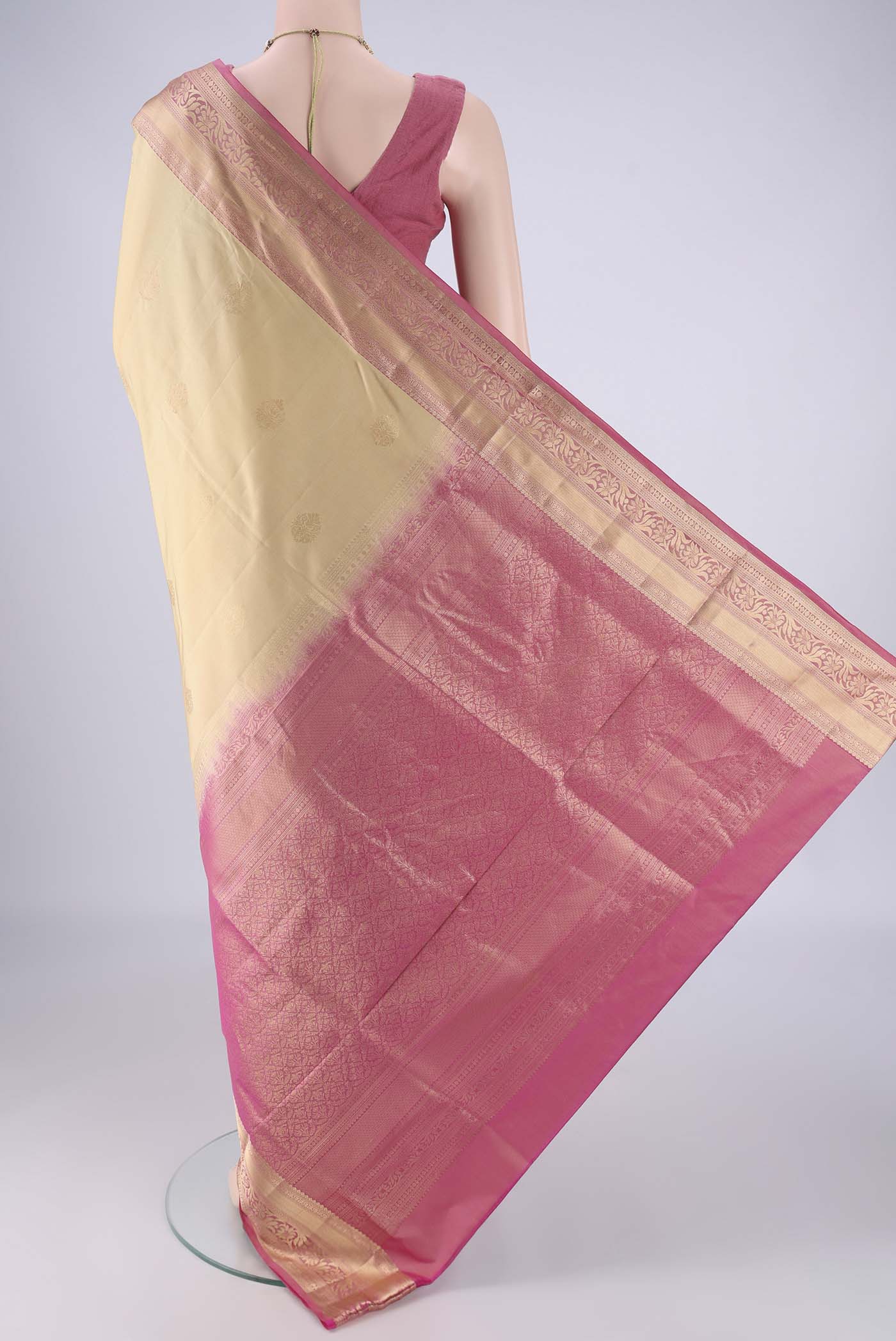Flat view of Beige Soft Silk Saree with Zari Butta on the body and Zari Border. 