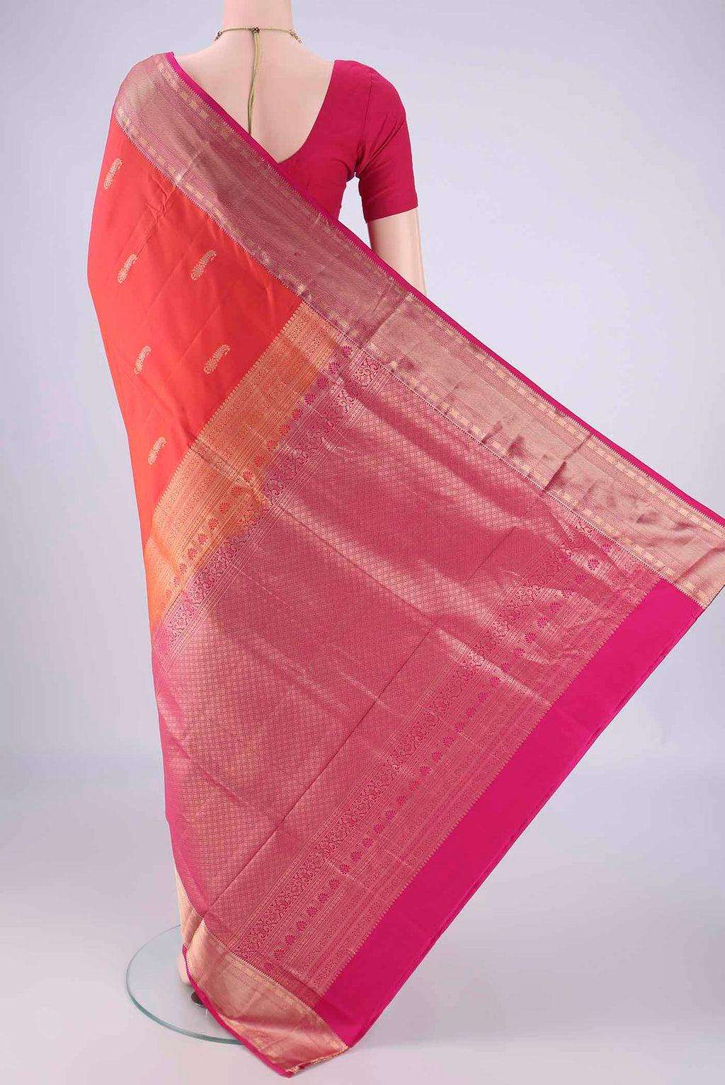 Flat view of Orange Soft Silk Saree with Zari Butta on the body and Zari Border. 
