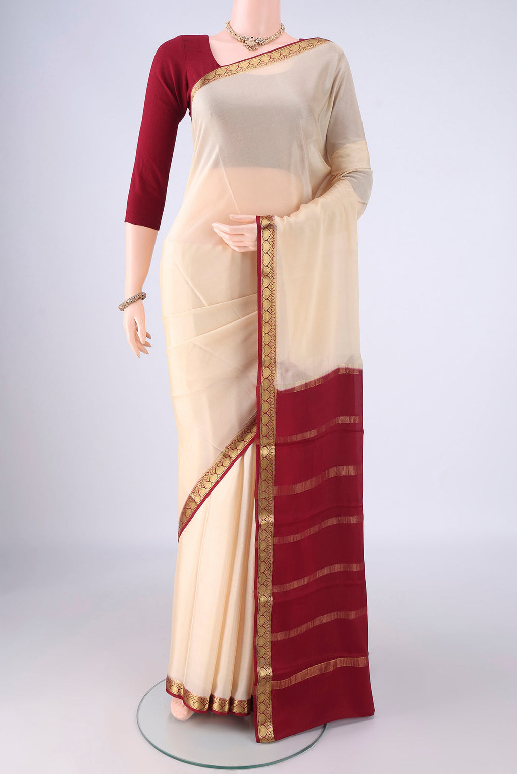 Cream Mysore Crepe Saree with Plain Body and Zari Border.  displayed on a mannequin