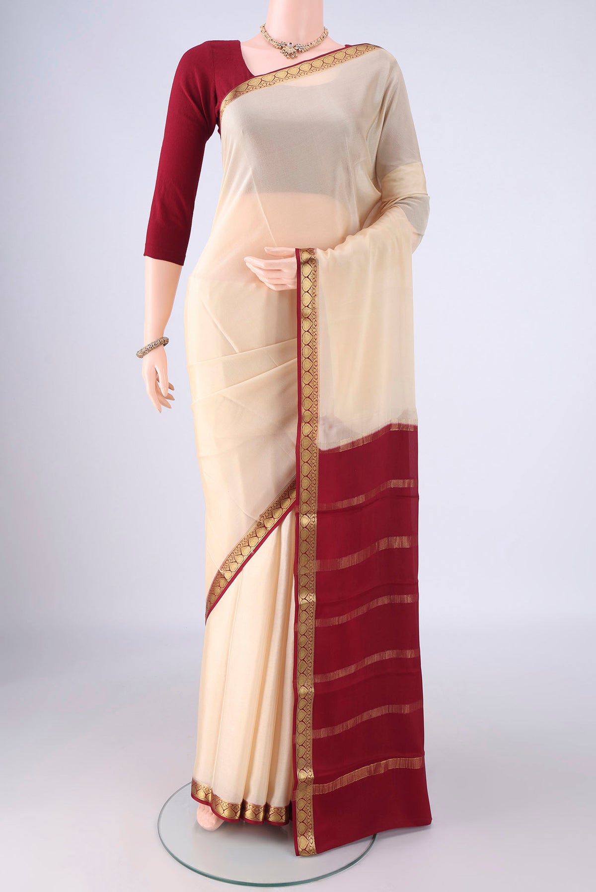 Cream Mysore Crepe Saree with Plain Body and Zari Border.  displayed on a mannequin