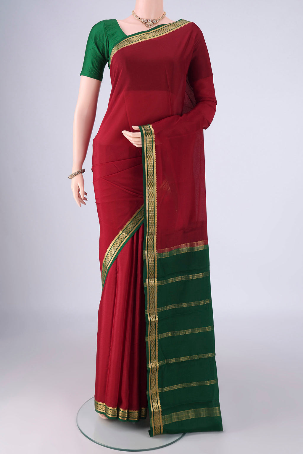 Maroon Mysore Crepe Saree with Plain Body and Zari Border.  displayed on a mannequin