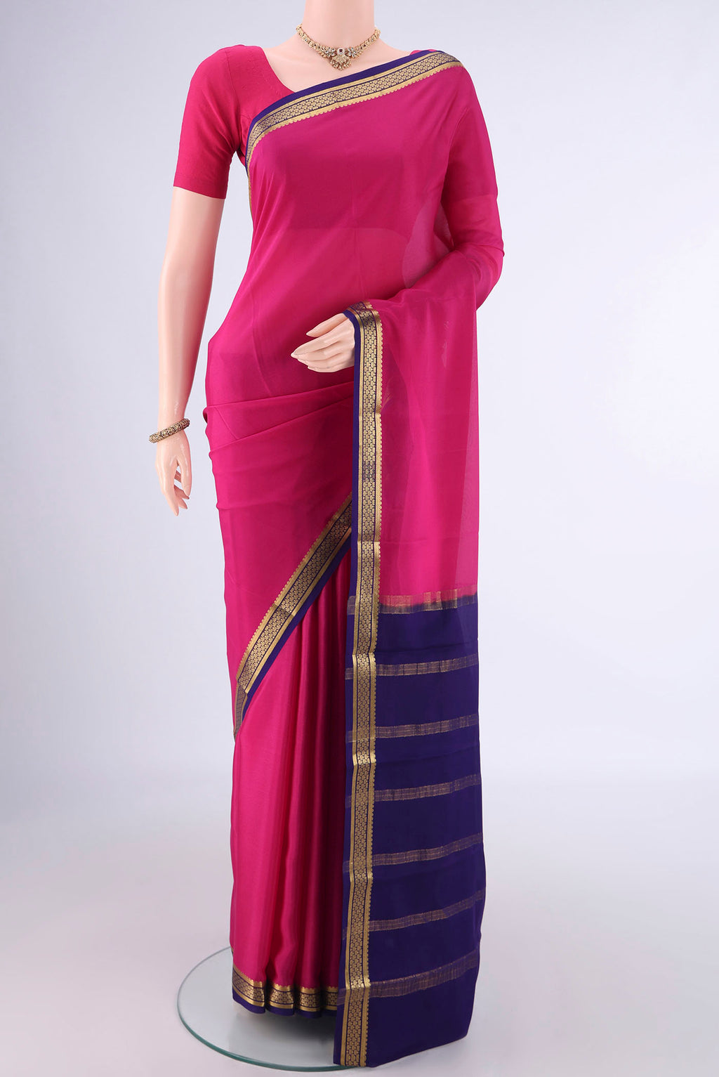 Rani Pink Mysore Crepe Saree with Plain Body and Zari Border.  displayed on a mannequin