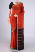 Rust Mysore Crepe Saree with Plain Body and Zari Border.  displayed on a mannequin