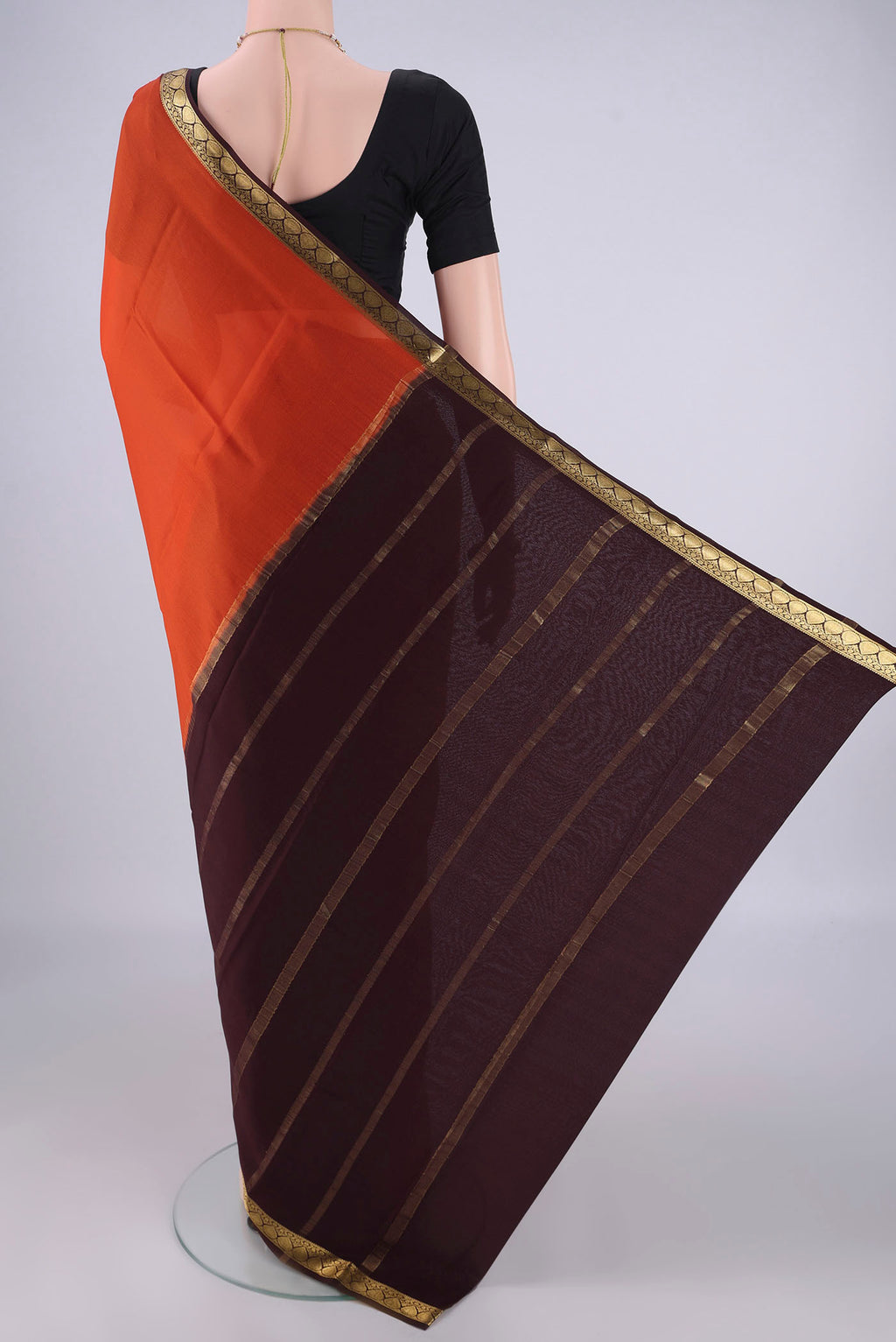 Flat view of Rust Mysore Crepe Saree with Plain Body and Zari Border. 