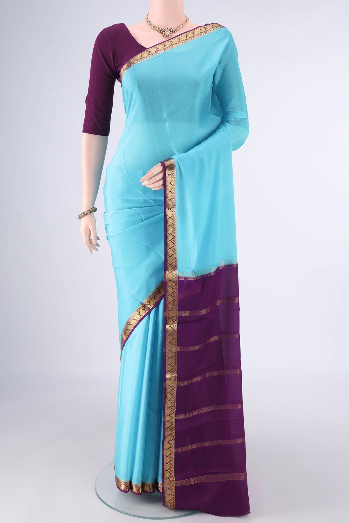 Sky Blue Mysore Crepe Saree with Plain Body and Zari Border.  displayed on a mannequin