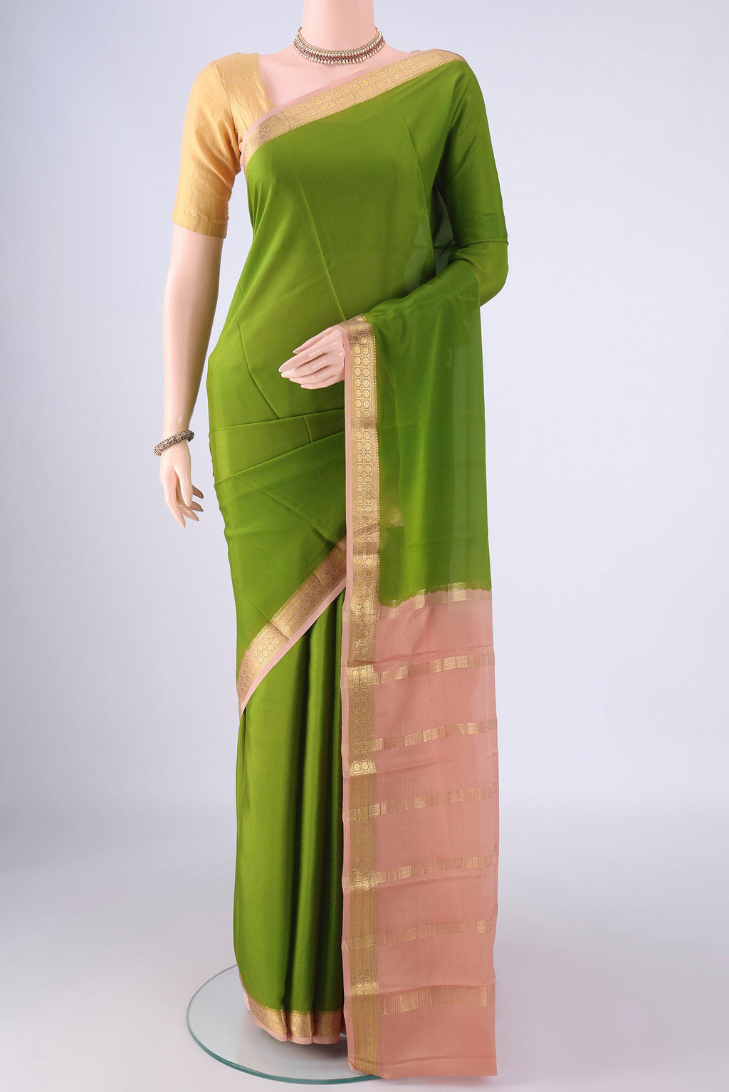 Green Mysore Crepe Saree with Plain Body and Zari Border.  displayed on a mannequin