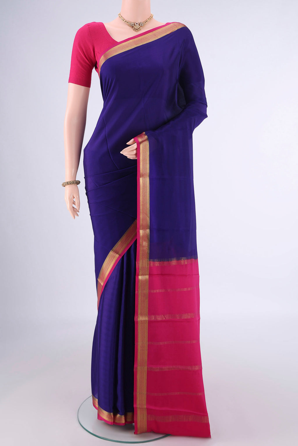 Navy Blue Mysore Crepe Saree with Plain Body and Zari Border.  displayed on a mannequin