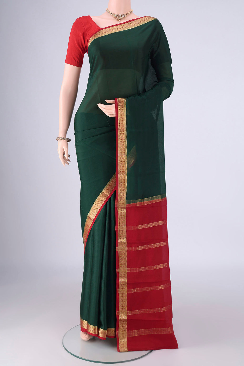 Bottle Green Mysore Crepe Saree with Plain Body and Zari Border.  displayed on a mannequin