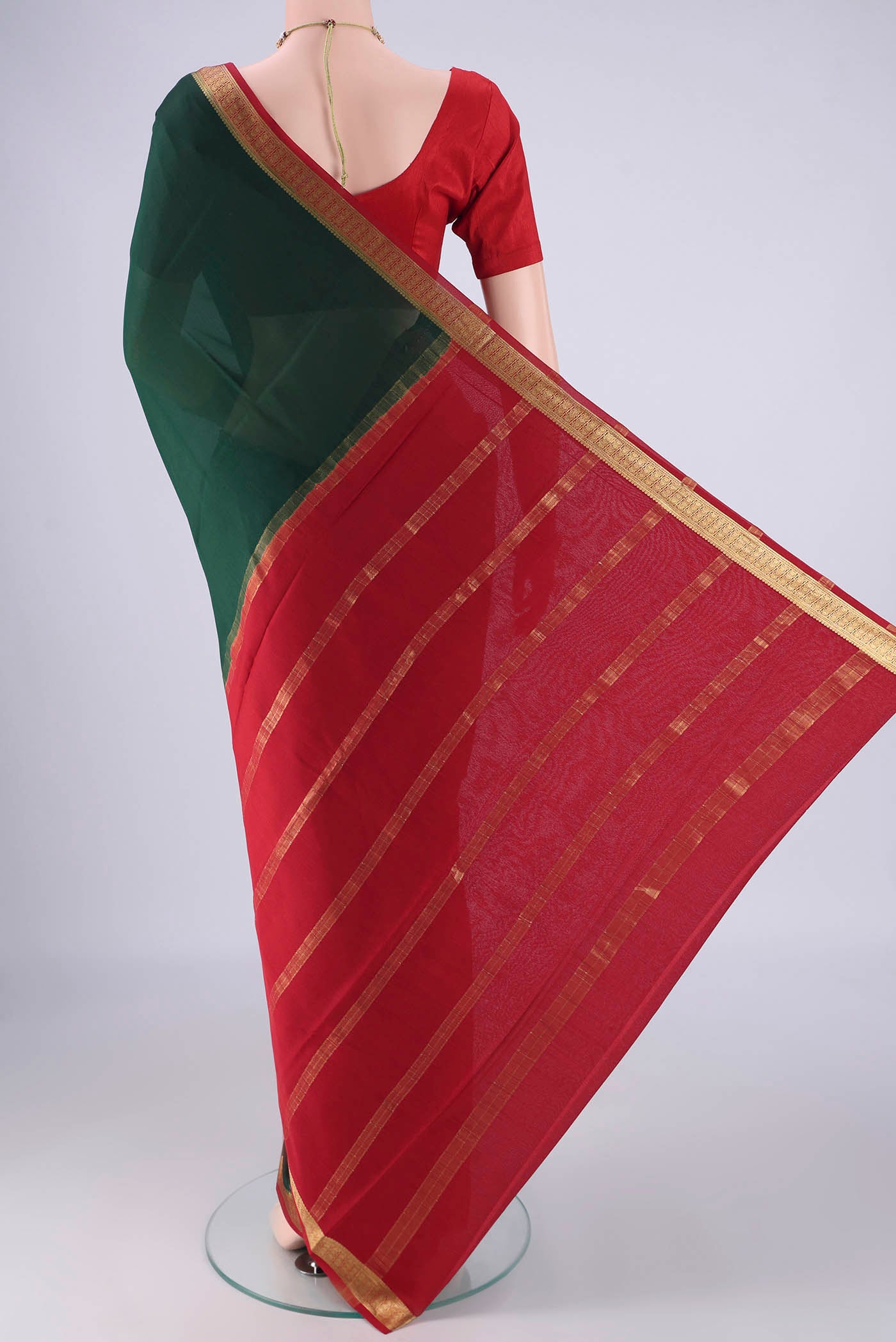 Flat view of Bottle Green Mysore Crepe Saree with Plain Body and Zari Border. 