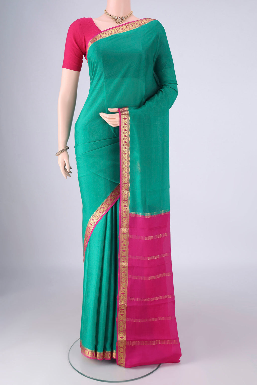 Sea Green Mysore Crepe Saree with Plain Body and Zari Border.  displayed on a mannequin