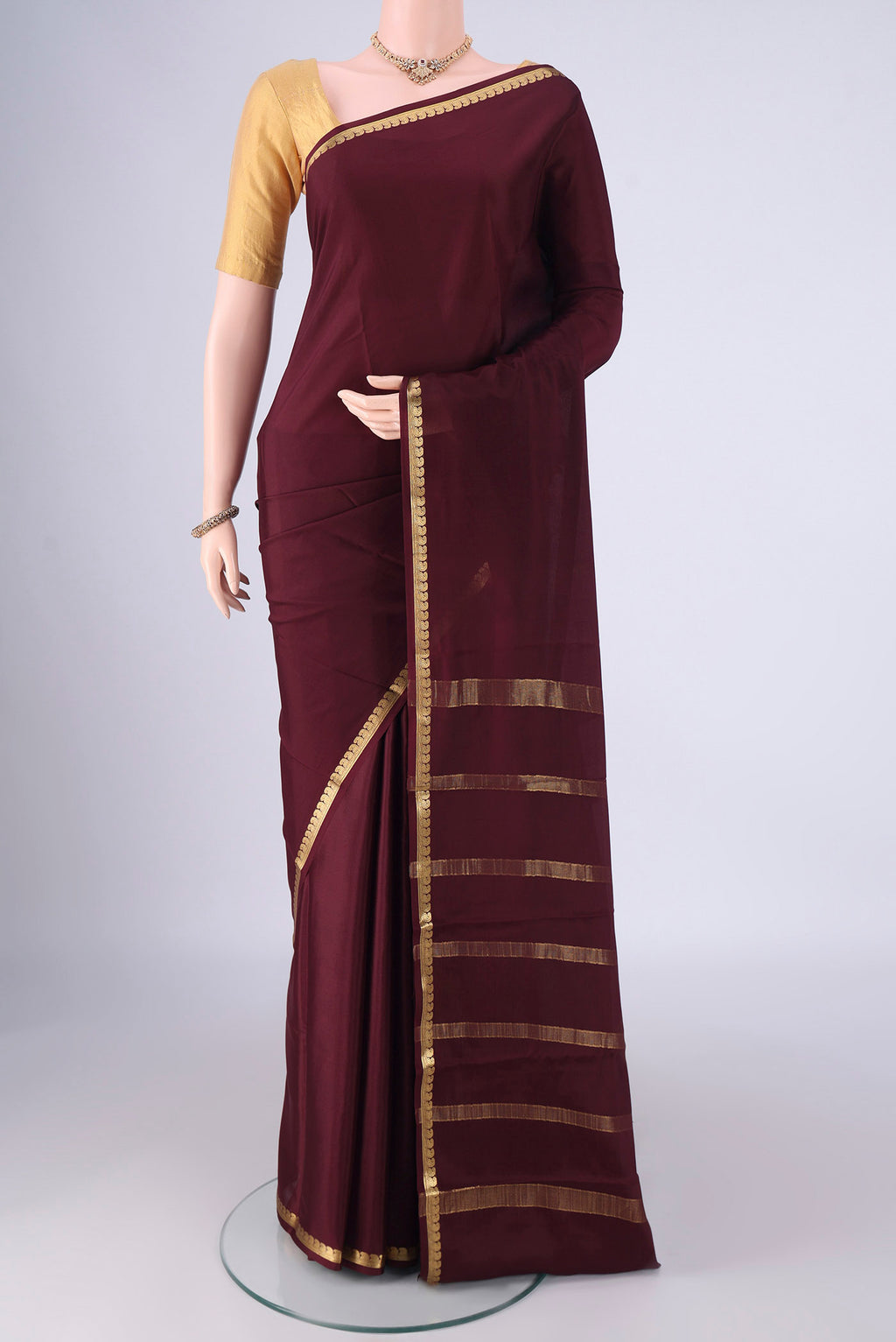 Coffee Brown Mysore Crepe Saree with Plain Body and Zari Border.  displayed on a mannequin