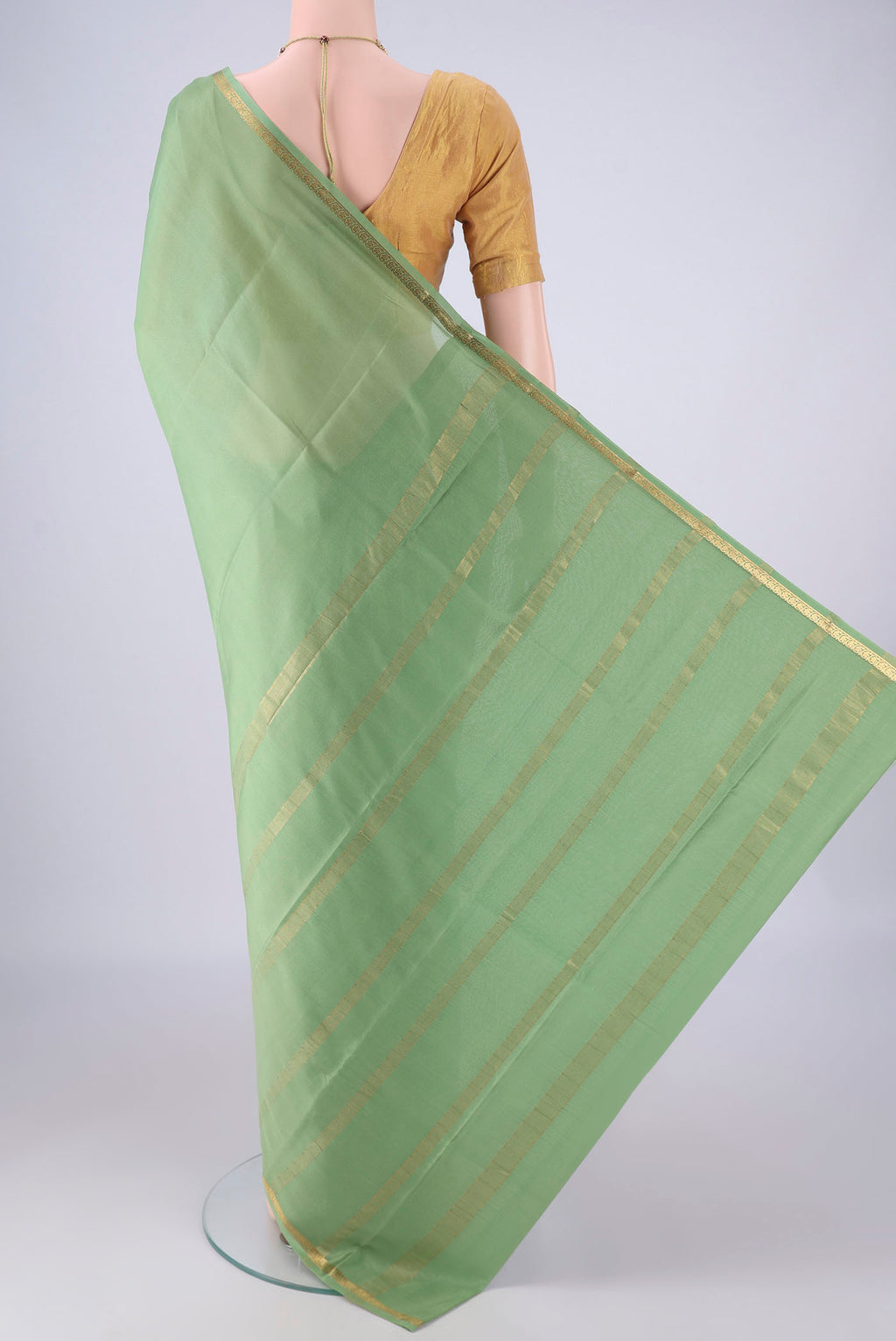 Flat view of Sage Green Mysore Crepe Saree with Plain Body and Zari Border. 