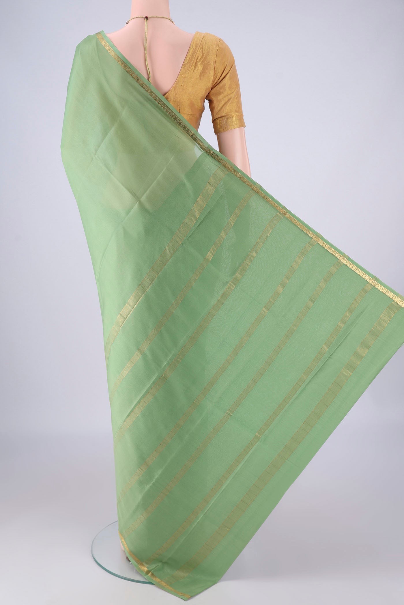 Flat view of Sage Green Mysore Crepe Saree with Plain Body and Zari Border. 