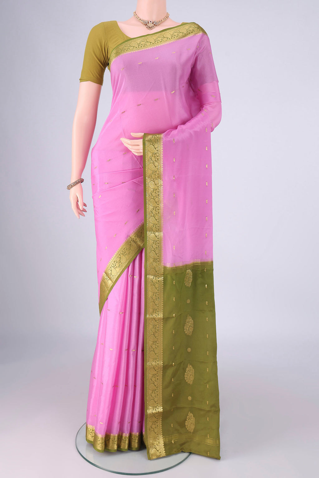 Rose pink Mysore Crepe Saree with Zari Butta on the body and Zari Border.  displayed on a mannequin
