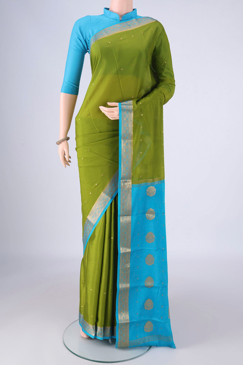 Mehandi Green Mysore Crepe Saree with Zari Butta on the body and Zari Border.  displayed on a mannequin
