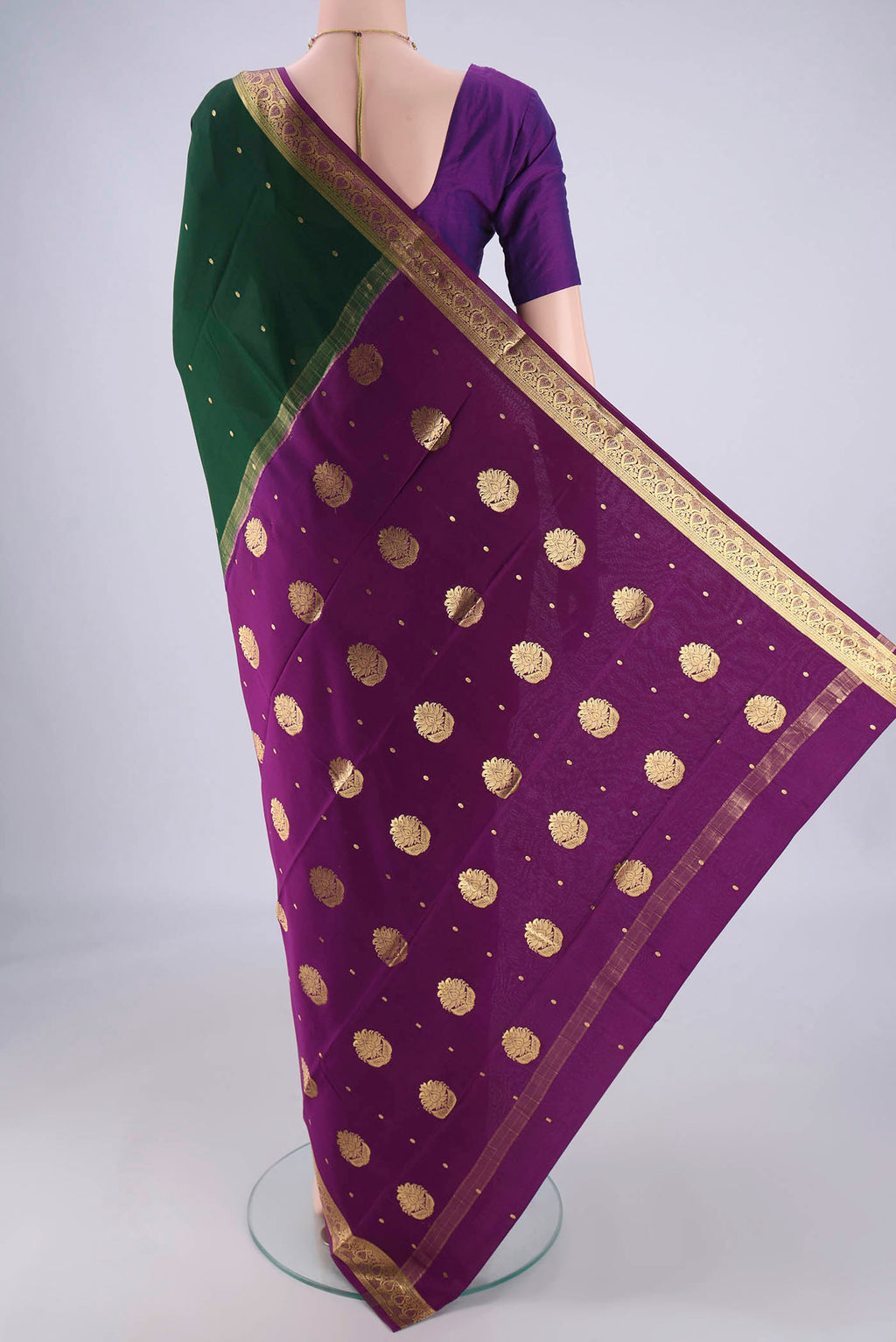 Flat view of Bottle Green Mysore Crepe Saree with Zari Butta on the body and Zari Border. 