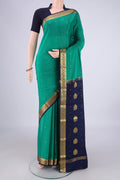 Sea Green Mysore Crepe Saree with Zari Butta on the body and Zari Border.  displayed on a mannequin