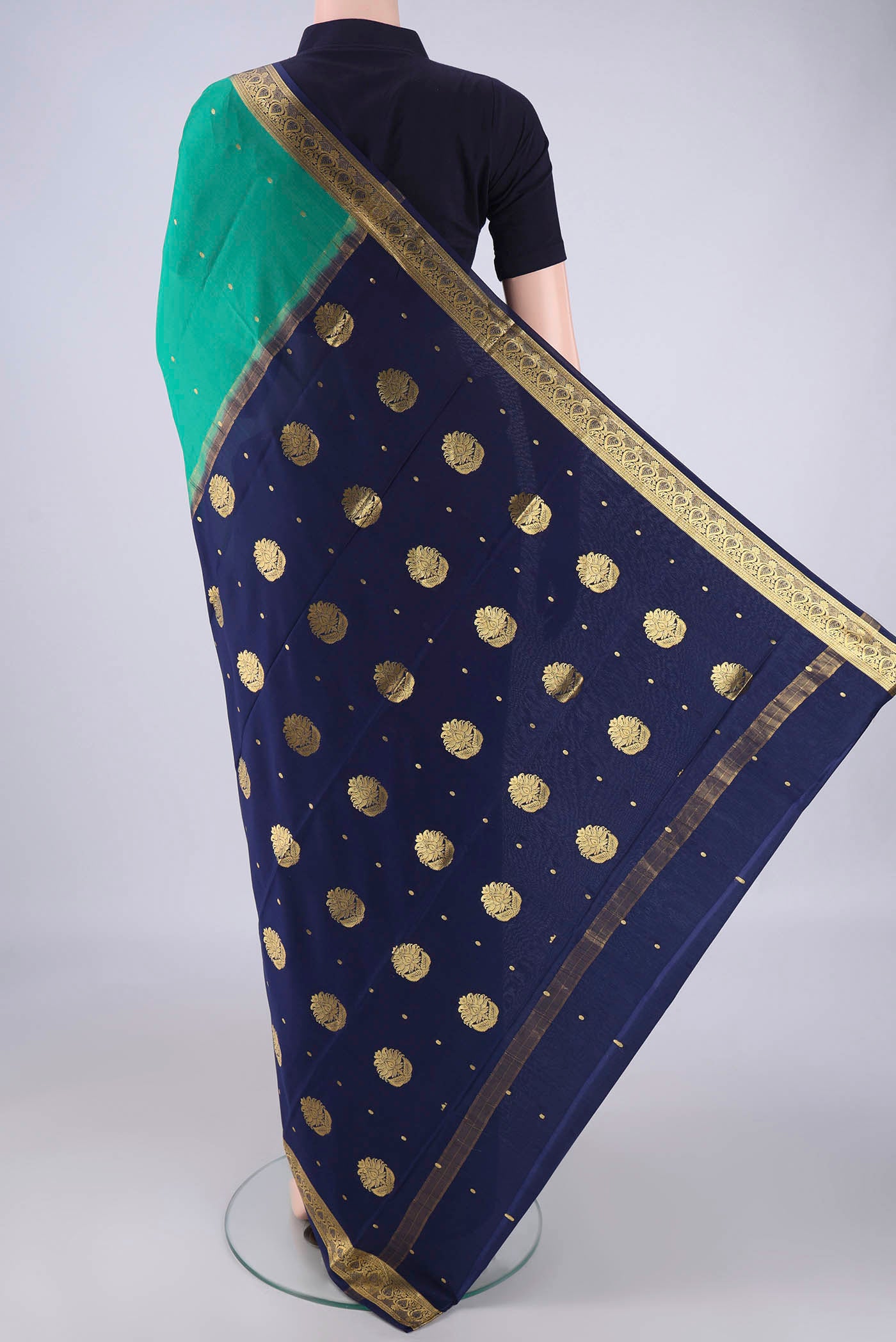 Flat view of Sea Green Mysore Crepe Saree with Zari Butta on the body and Zari Border. 