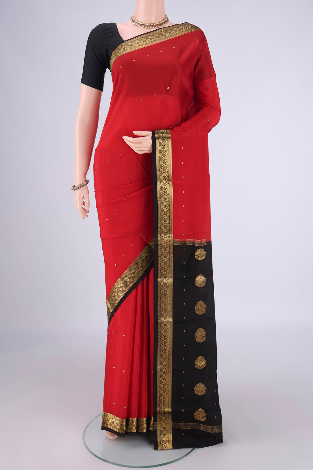 Red Mysore Crepe Saree with Zari Butta on the body and Zari Border.  displayed on a mannequin