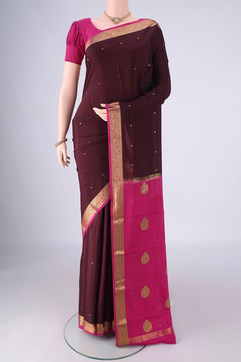 Brown Mysore Crepe Saree with Zari Butta on the body and Zari Border.  displayed on a mannequin