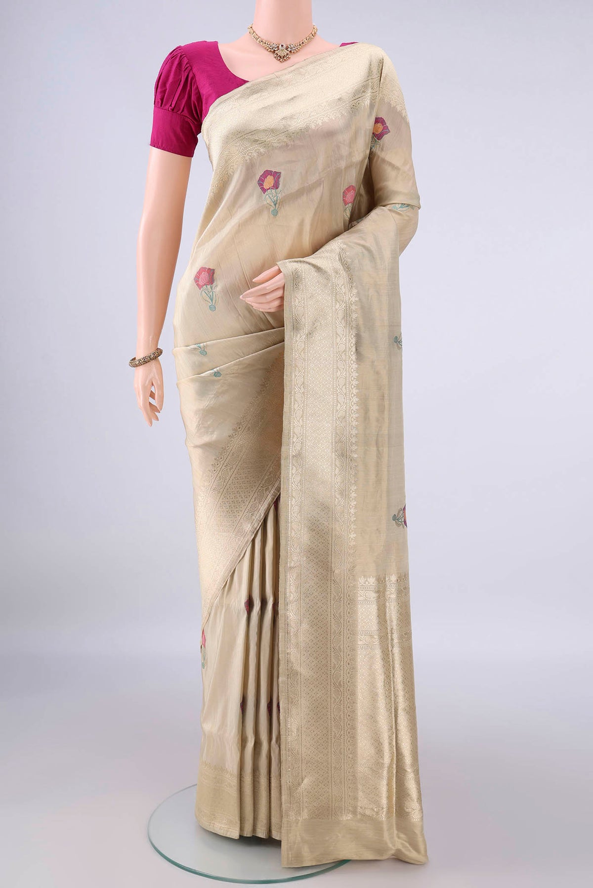 Beige Banarasi Saree with Zari And Thread Butta on the body and Zari Border.  displayed on a mannequin