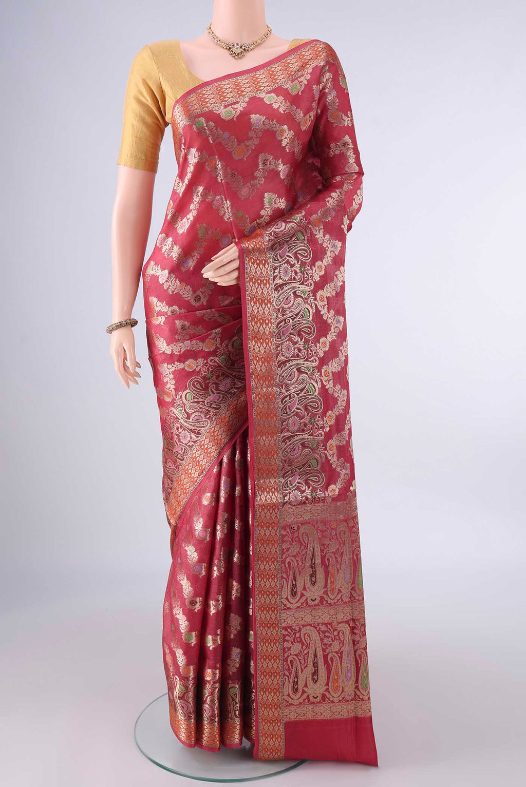 Rust Banarasi Tussar Saree with Zari Brocade on the body and Zari And Thread Border.  displayed on a mannequin